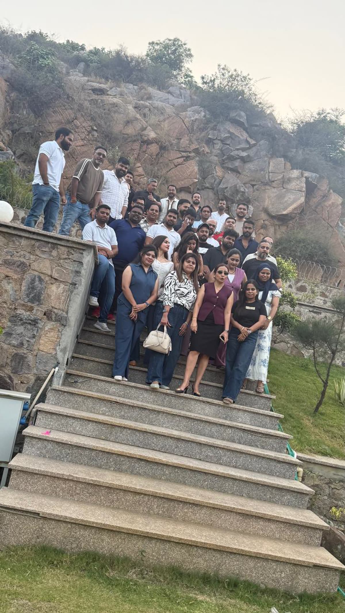 Corporate team at Sidneyland Hill Retreat with Aravalli hills backdrop