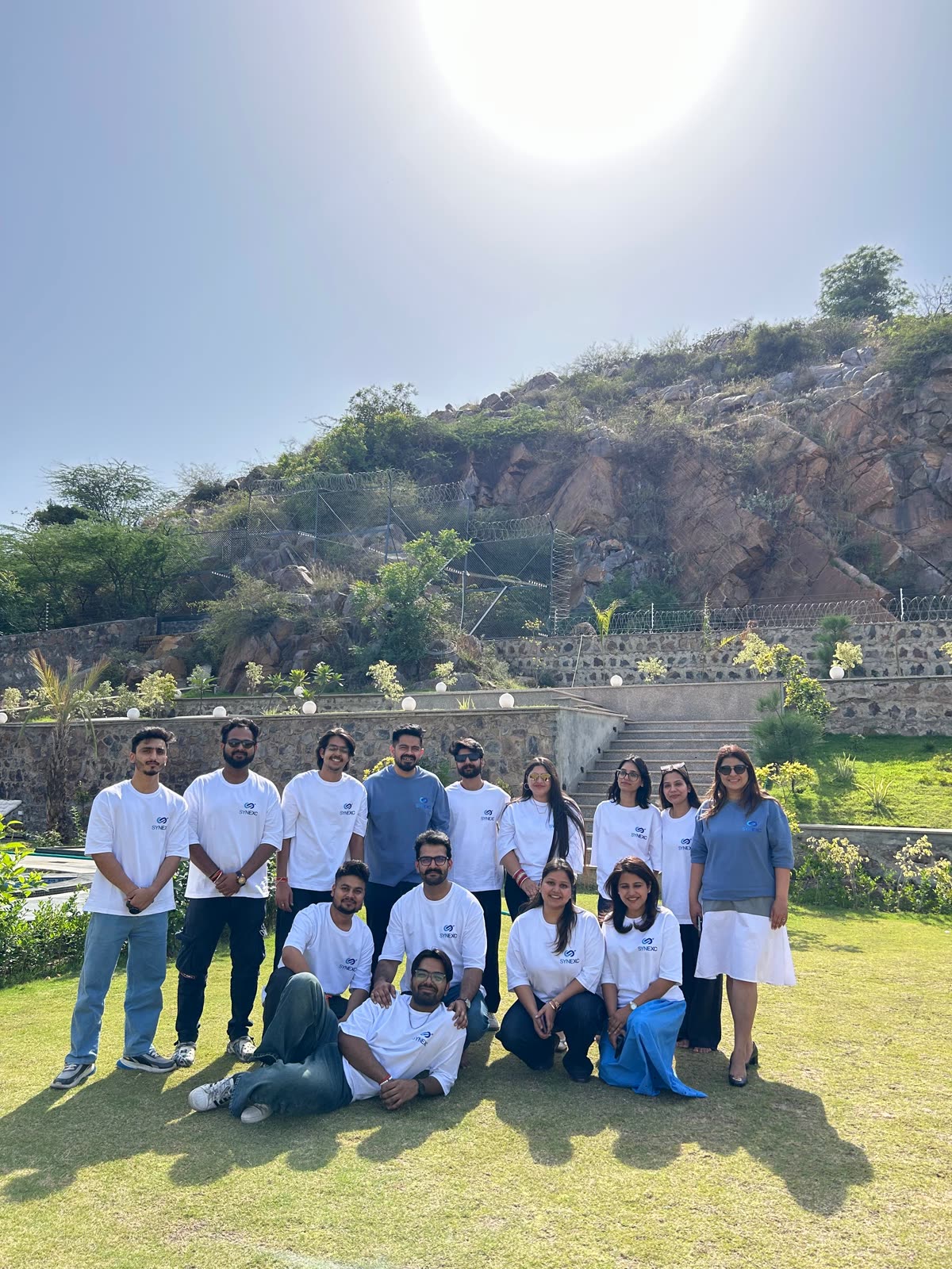 Guest group photo on the stone steps at Sidneyland Hill Retreat